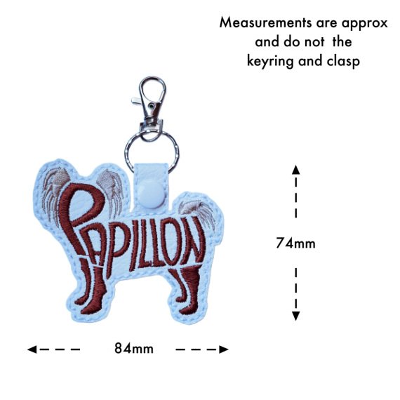White Papillon word art keyring with size guide showing the embroidered dog design measures approximately 74mm x 84mm, excluding the keyring and lobster clasp.
