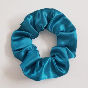 Peacock teal satin scrunchie with glossy finish on a white background.