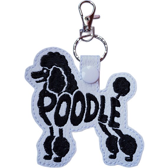 White embroidered Poodle word art keyring made from faux leather, with stitched breed lettering and silver metal hardware.