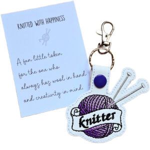 Proud Knitter keyring with purple embroidered yarn ball, silver knitting needles and matching keepsake card reading 'Knitted with happiness'.