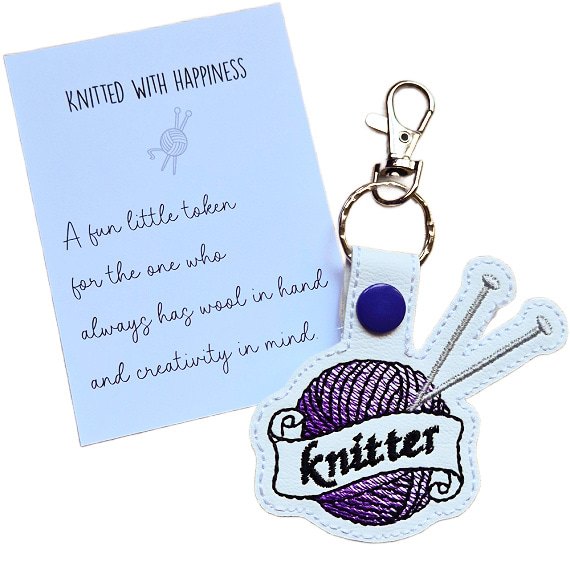 Proud Knitter keyring with purple embroidered yarn ball, silver knitting needles and matching keepsake card reading 'Knitted with happiness'.