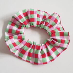 Red, green and white gingham cotton scrunchie photographed on a white background.