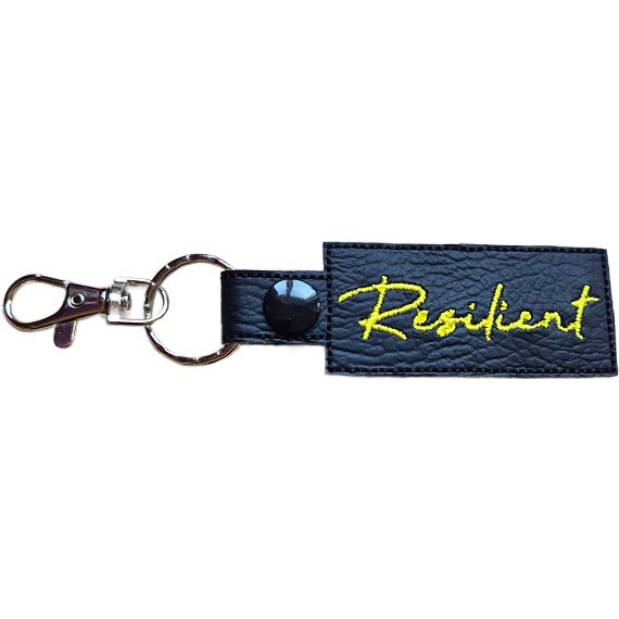 Embroidered Resilient keyring in black faux leather, with the word 'Resilient' stitched in yellow and sturdy metal keyring hardware.