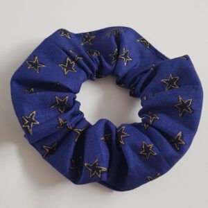 Royal blue cotton scrunchie with gold star print on a white background