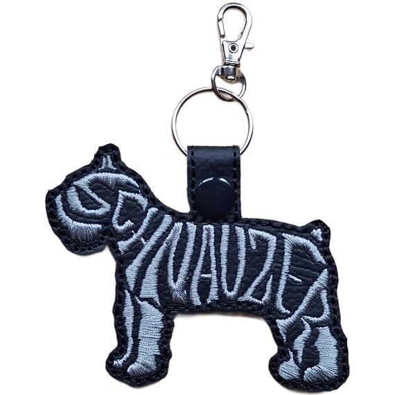 Black embroidered Schnauzer word art keyring made from faux leather, with grey stitched breed lettering and silver metal hardware.