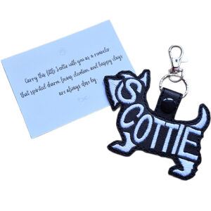Black embroidered Scottie word art keyring shown beside its keepsake card with a sentimental dog lover message.