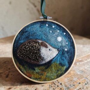Needle felted hedgehog. A decorative hanging framed in an embroidery ring. All proceeds to The Stroke Association