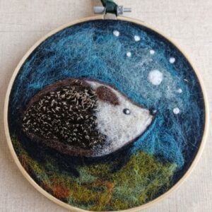 Needle felted hedgehog. A decorative hanging framed in an embroidery ring. All proceeds to The Stroke Association