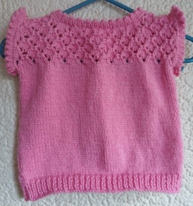 Hand-knitted baby top. Pink. Approx 0 to 3 mths. All proceeds to The Stroke Association