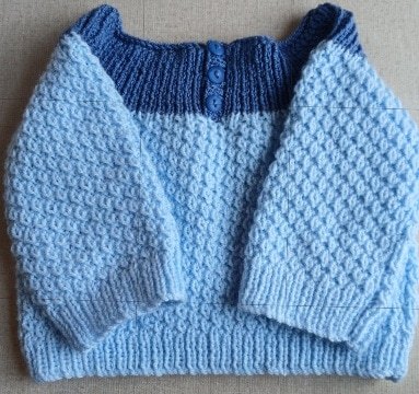 Hand- knitted baby jumper in blue. Approx 3 to 6 mths. All proceeds to The Stroke Association