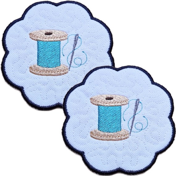 Set of two embroidered sewing candle coasters with stitched thread spool designs, needle and thread details, scalloped edging and matching craft room style.