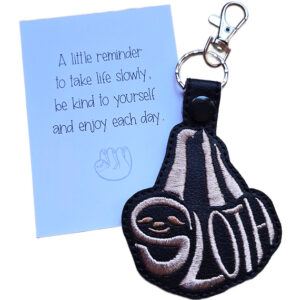 Black faux leather sloth word art keyring with light embroidered 'Sloth' lettering, shown beside a white keepsake card with gentle reminder wording.
