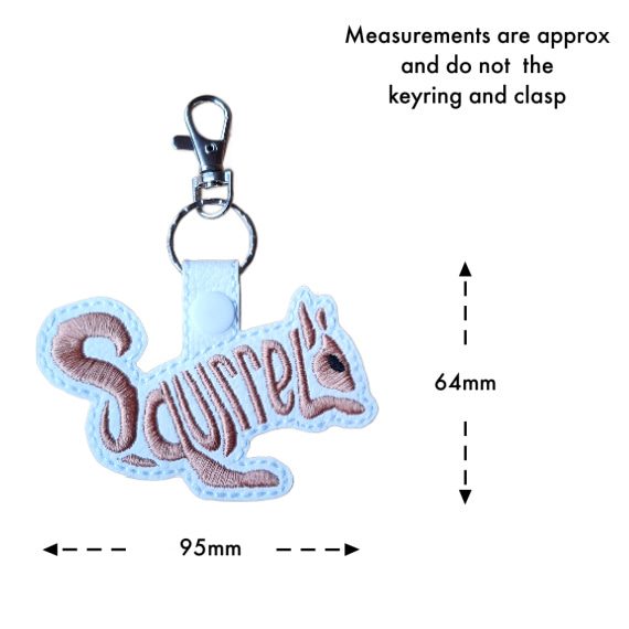 White faux leather squirrel word art keyring with brown embroidered 'Squirrel' lettering, shown with measurement arrows indicating an approximate size of 64mm x 95mm, excluding the keyring and clasp.