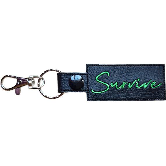 Embroidered Survive keyring in black faux leather, with the word 'Survive' stitched in green and sturdy metal keyring hardware.