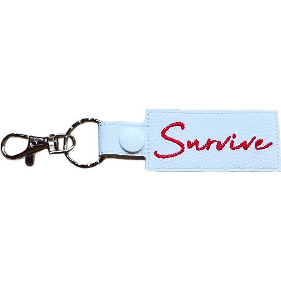 Embroidered Survive keyring in white faux leather, with the word 'Survive' stitched in red and sturdy metal keyring hardware.