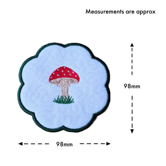 Toadstool candle coaster size guide showing the embroidered scalloped coaster measuring approximately 98mm x 98mm.