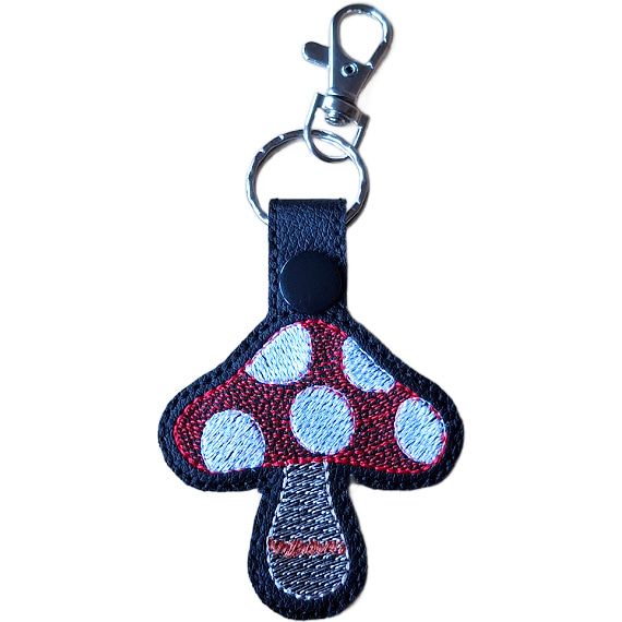 Black faux leather toadstool mushroom keyring with a red spotted cap, stitched stem detail and silver lobster clasp.