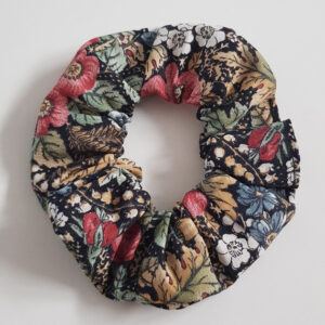 Grey and black vintage rose floral cotton scrunchie on a white background.