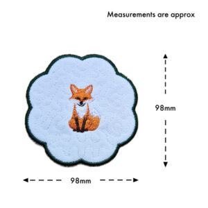 Woodland fox candle coaster size guide showing the embroidered scalloped coaster measuring approximately 98mm by 98mm.