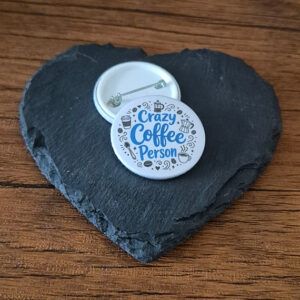 Crazy Coffee Person funny coffee lover badge with playful lettering and small coffee cup accents, available as a badge, magnet or keyring.