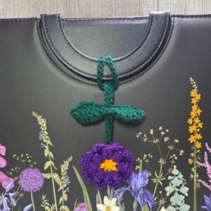 Purple Crochet Bag Charm Hanging From Handle