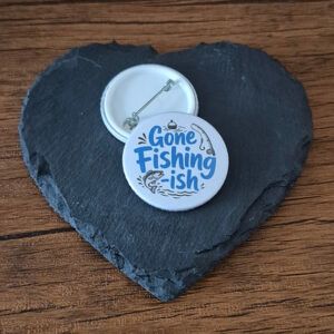 Gone Fishing-ish funny fisherman badge with playful blue lettering, fishing themed accents and a fish illustration, available as a badge or keyring.