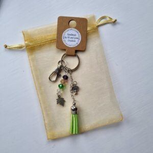 Handmade Beaded Bag Charm with Earthy Tones and Green Tassel