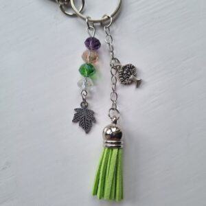 Handmade Beaded Bag Charm with Earthy Tones and Green Tassel