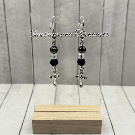 Handmade gemstone earrings featuring matte black obsidian beads, polished hematite beads, sparkling Czech crystal beads and detailed silver-tone cross charms suspended from stainless steel ear wires.