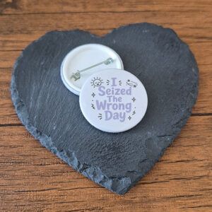 Funny mood badge design with the phrase 'I seized the wrong day' in playful lettering, decorated with small sparkle and doodle accents.