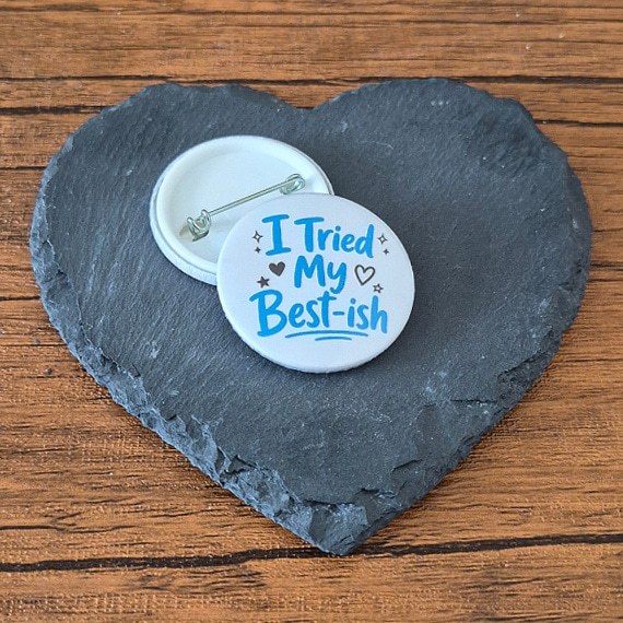 I Tried My Best-ish funny mood badge with playful blue lettering, heart details and small sparkle accents, available as a badge, magnet or keyring.
