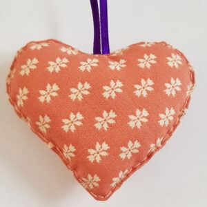 Orange And Purple Hanging Heart Decoration On A White Background