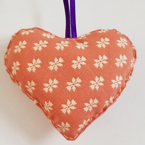 Orange And Purple Hanging Heart Decoration On A White Background