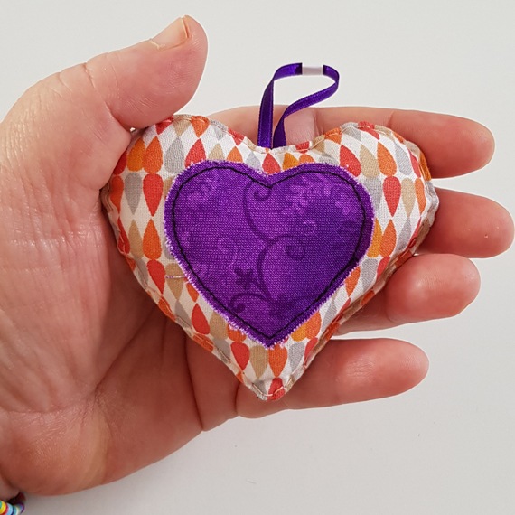 Orange And Purple Hanging Heart Decoration On A White Background