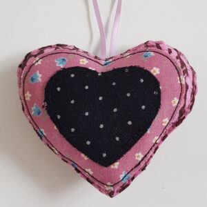 Pink Floral Hanging Heart Decoration with a black and white polka dot centre on a white background