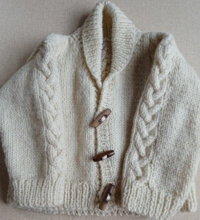 Hand-knitted baby Aran wool jumper. Approx 0 to 3 mths. Proceeds to Charity