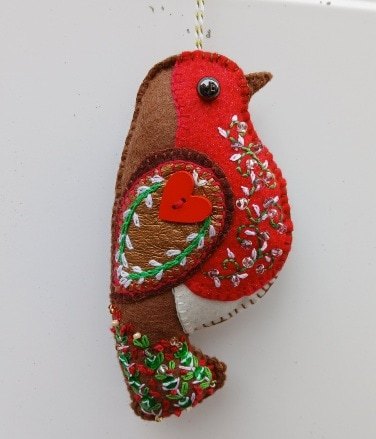 The robin. A symbol of hope, remembrance and fresh beginnings. A hand embroidered decoration. All proceeds to The Stroke Association.