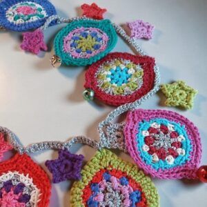 Festive party garland with glits, bells and pzazz. Silver crocheted. Proceeds to The Stroke Association.