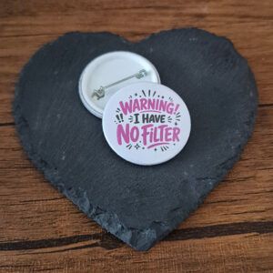 Funny sarcastic badge design with the phrase 'Warning I have no filter' in playful lettering, decorated with starburst and sparkle accents.