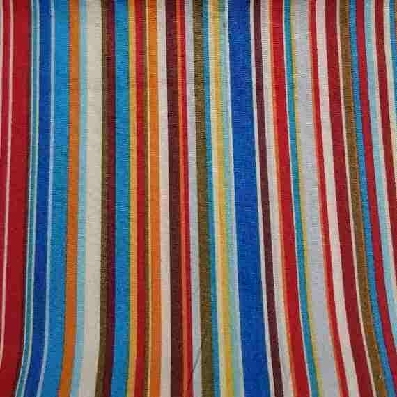 Bright multicoloured striped fabric with red, blue, orange, cream and earthy brown vertical stripes.