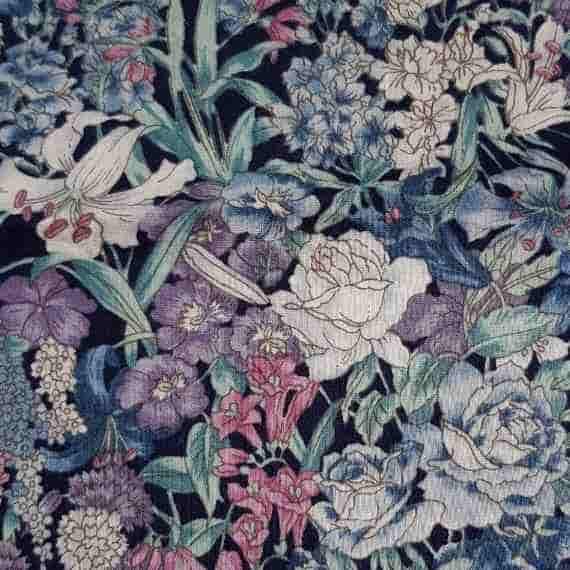 Dark mixed floral fabric with blue, purple, pink and cream flowers, roses, lilies and leafy details.