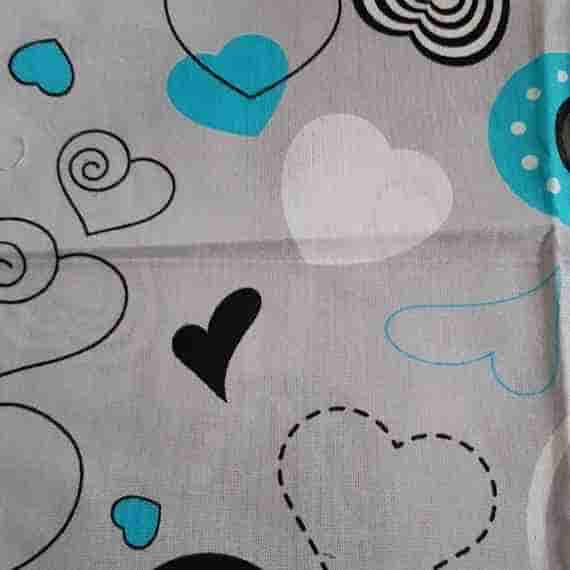 Grey heart fabric with turquoise blue, black and white hearts, playful swirls and dotted decorative details.