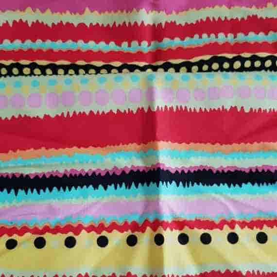 Colourful funky stripe fabric with red, pink, yellow, blue and black wavy stripes and dotted decorative details.