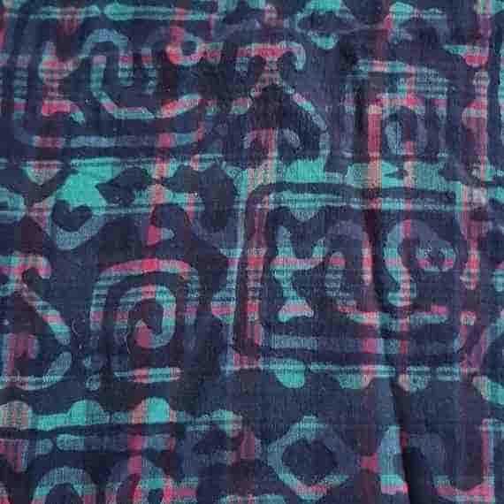 Teal and navy geometric fabric with abstract Aztec-style motifs, red plaid accents and dark patterned details.