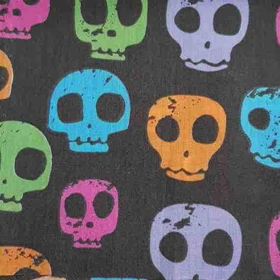 Black skull fabric with bright colourful skulls in blue, green, orange, pink and purple for a bold spooky pattern.