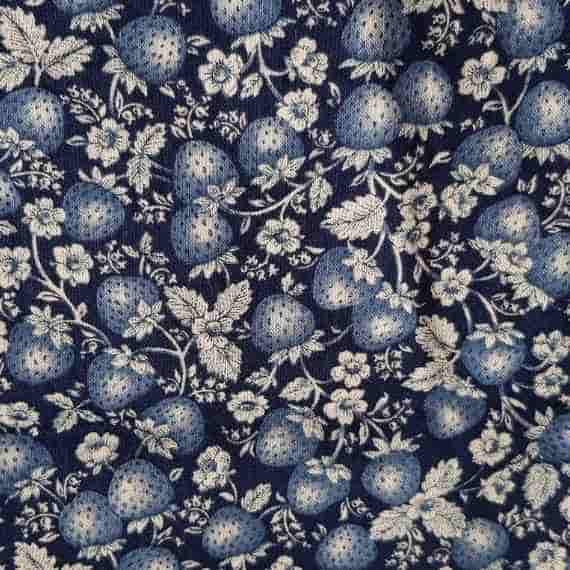 Dark navy fabric with blue strawberries, cream floral details, leaves and trailing vines.