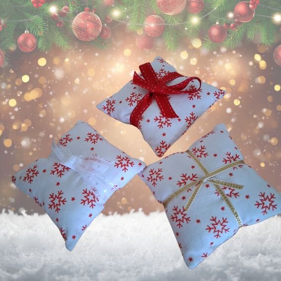 Christmas min cushions with red snow flakes on a white background