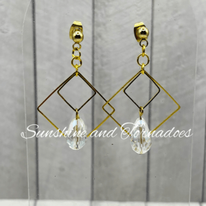 Handmade gold geometric drop earrings featuring faceted clear crystal teardrop pendants suspended within elegant gold diamond-shaped frames, creating lightweight statement jewellery with beautiful sparkle.