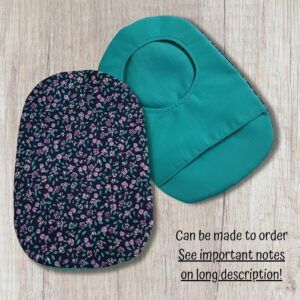 Two handmade stoma bag covers on a wooden background, showing a purple floral patterned front cover and a teal reverse cover with an opening, with text saying can be made to order.
