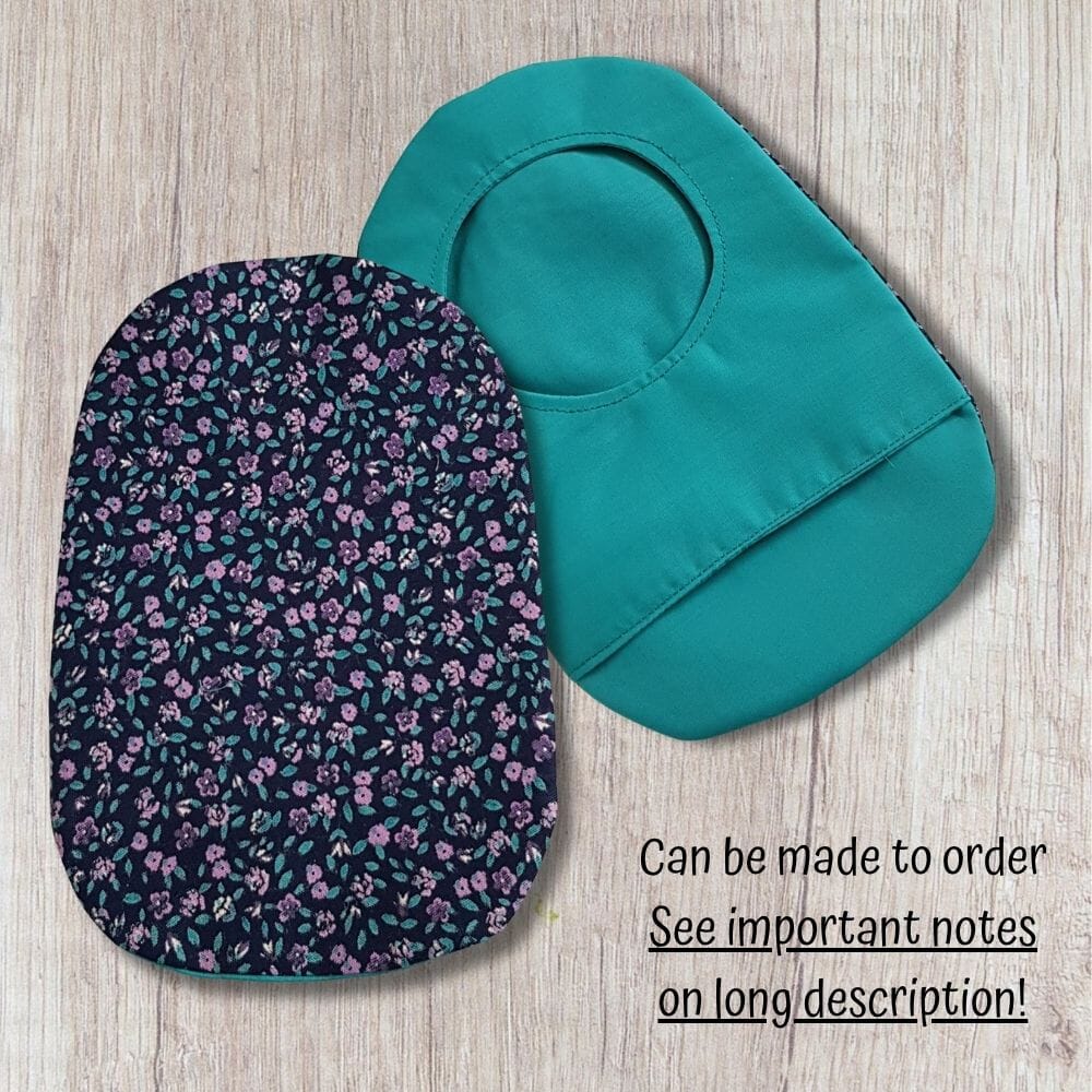 Two handmade stoma bag covers on a wooden background, showing a purple floral patterned front cover and a teal reverse cover with an opening, with text saying can be made to order.